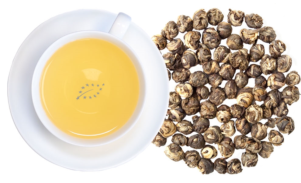 Tasse Jasmintee mit Jasmin-Perlen daneben